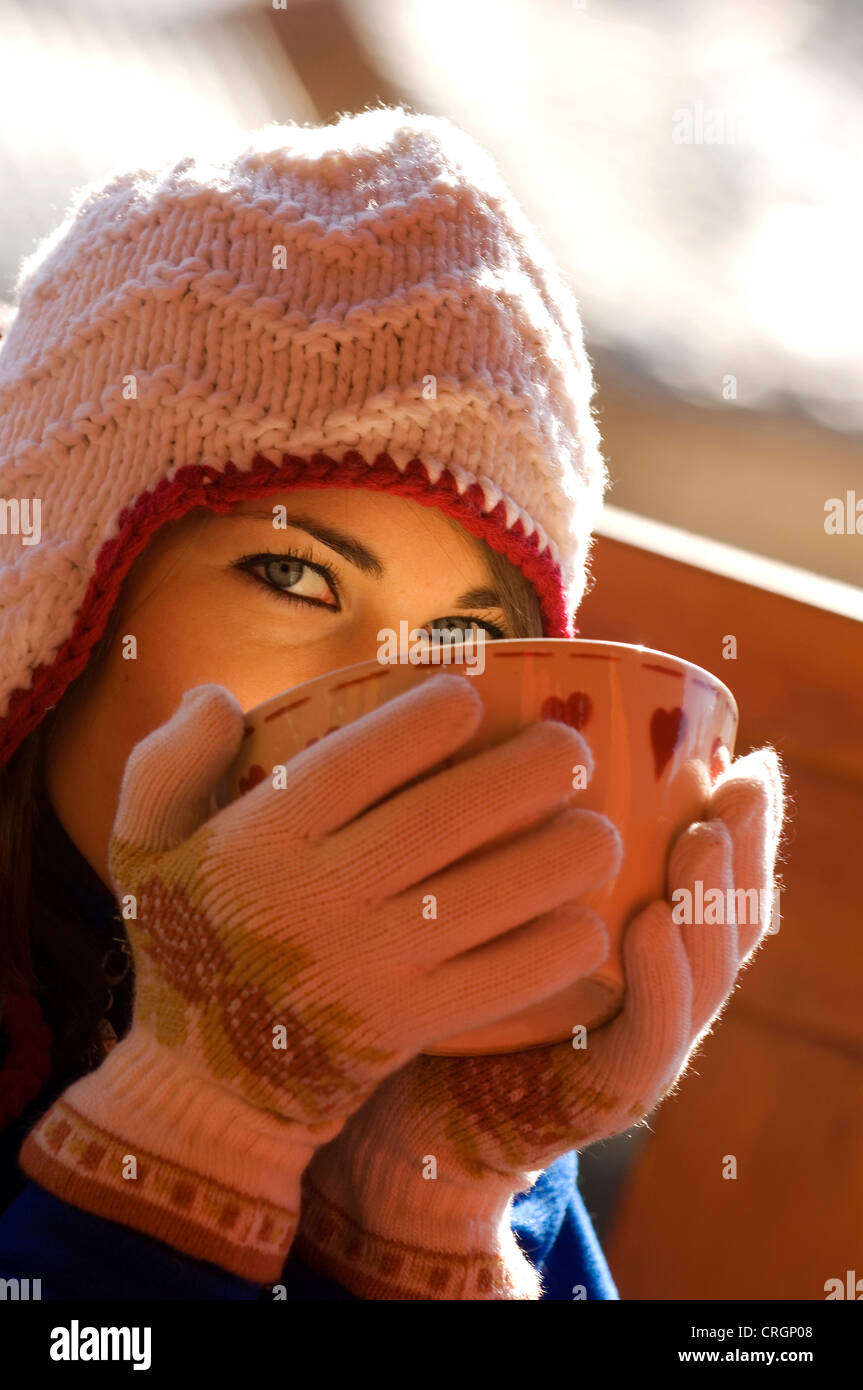 woman warming up with hot chocolate in a cup in winter Stock Photo