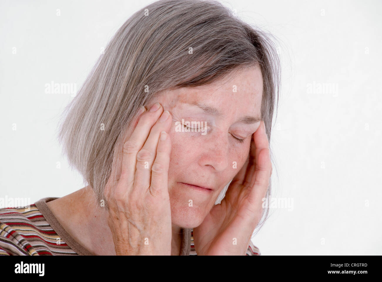 elder woman with headache, trying to concentrate Stock Photo