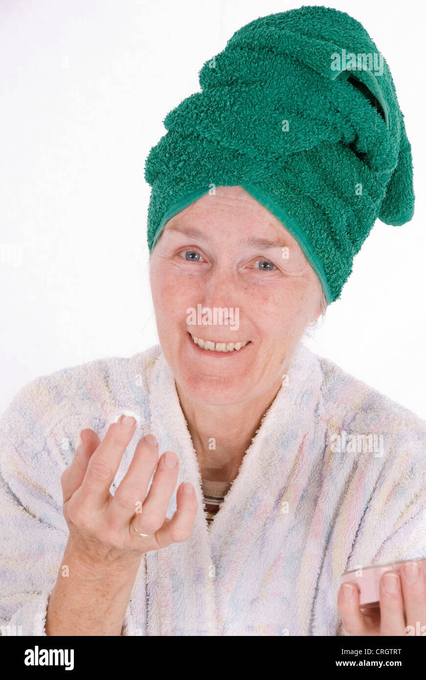 elderly woman takes face care with a moisturiser Stock Photo Alamy