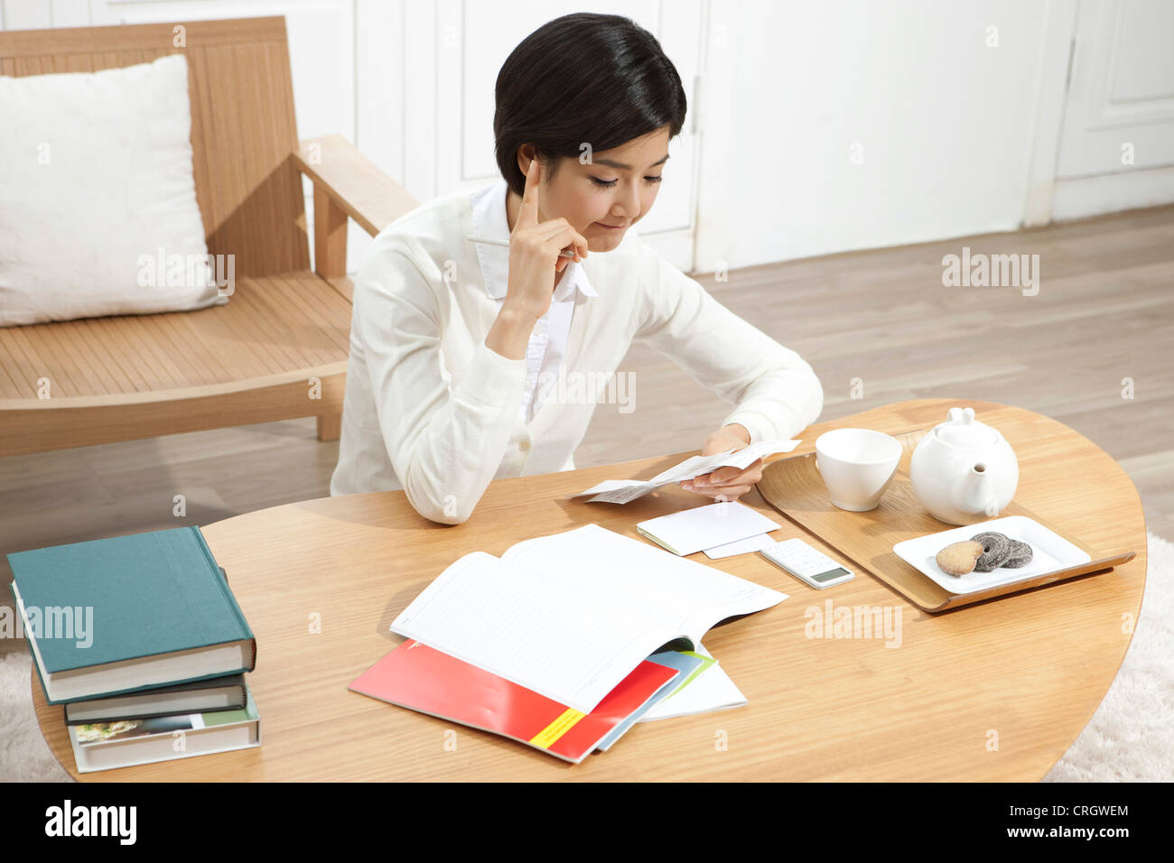 Young Woman Doing Finances At Desk Stock Photo Alamy
