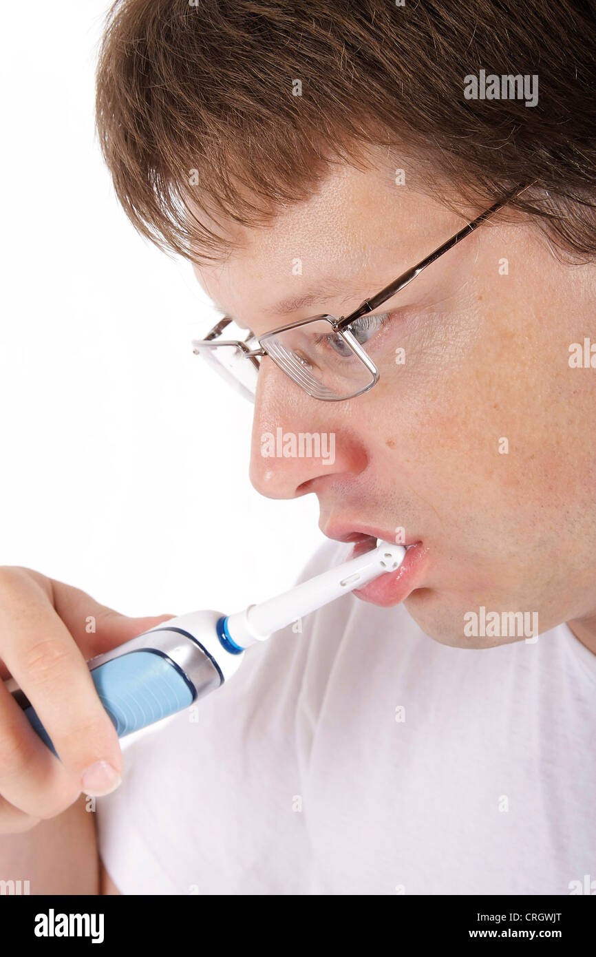 man brushing teeth with electric toothbrush Stock Photo Alamy