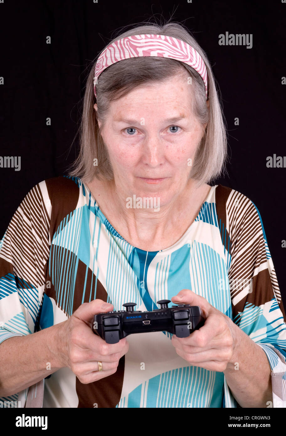 elderly woman with game pad Stock Photo Alamy