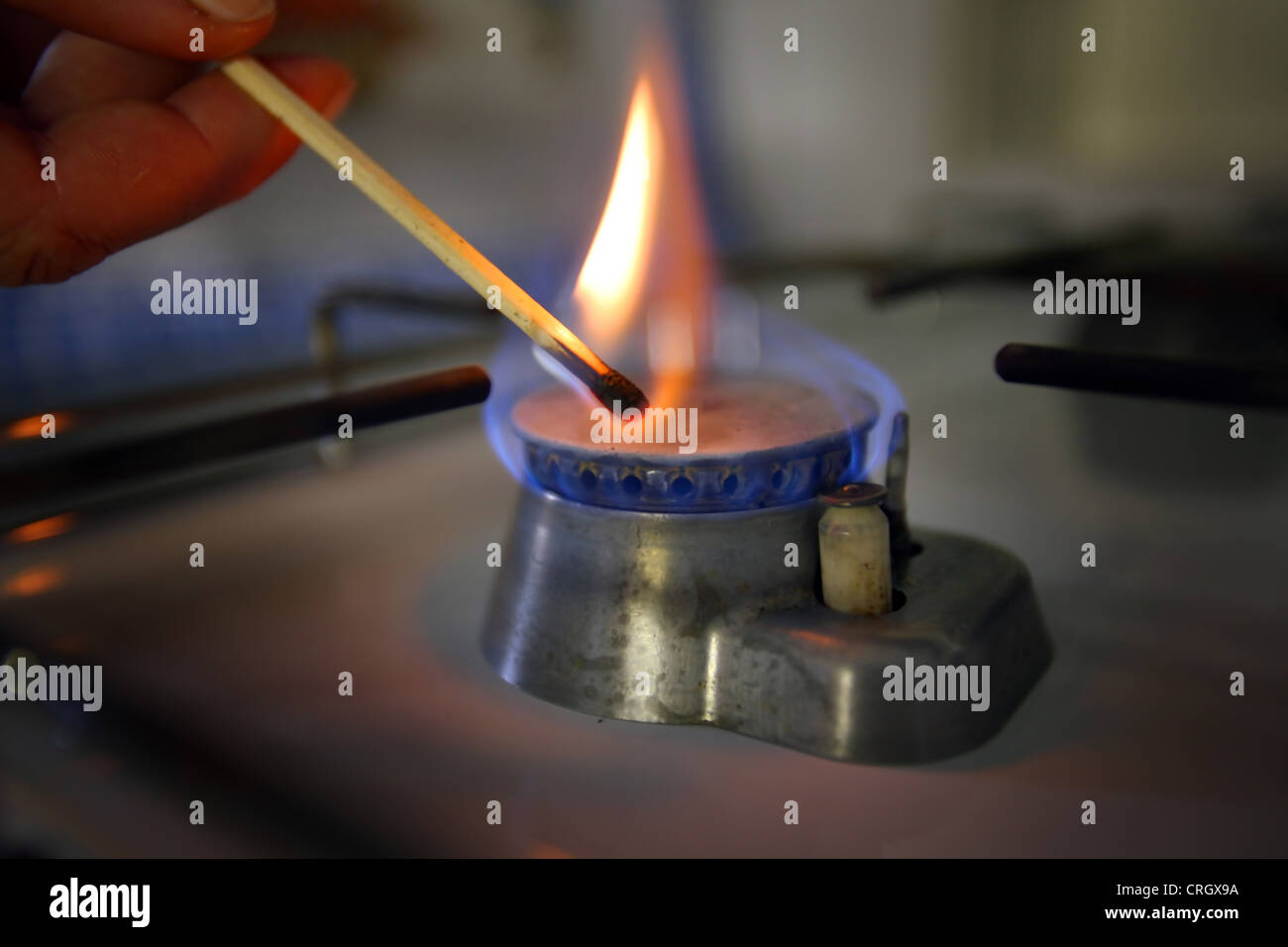 inflaming gas stove with a match Stock Photo Alamy
