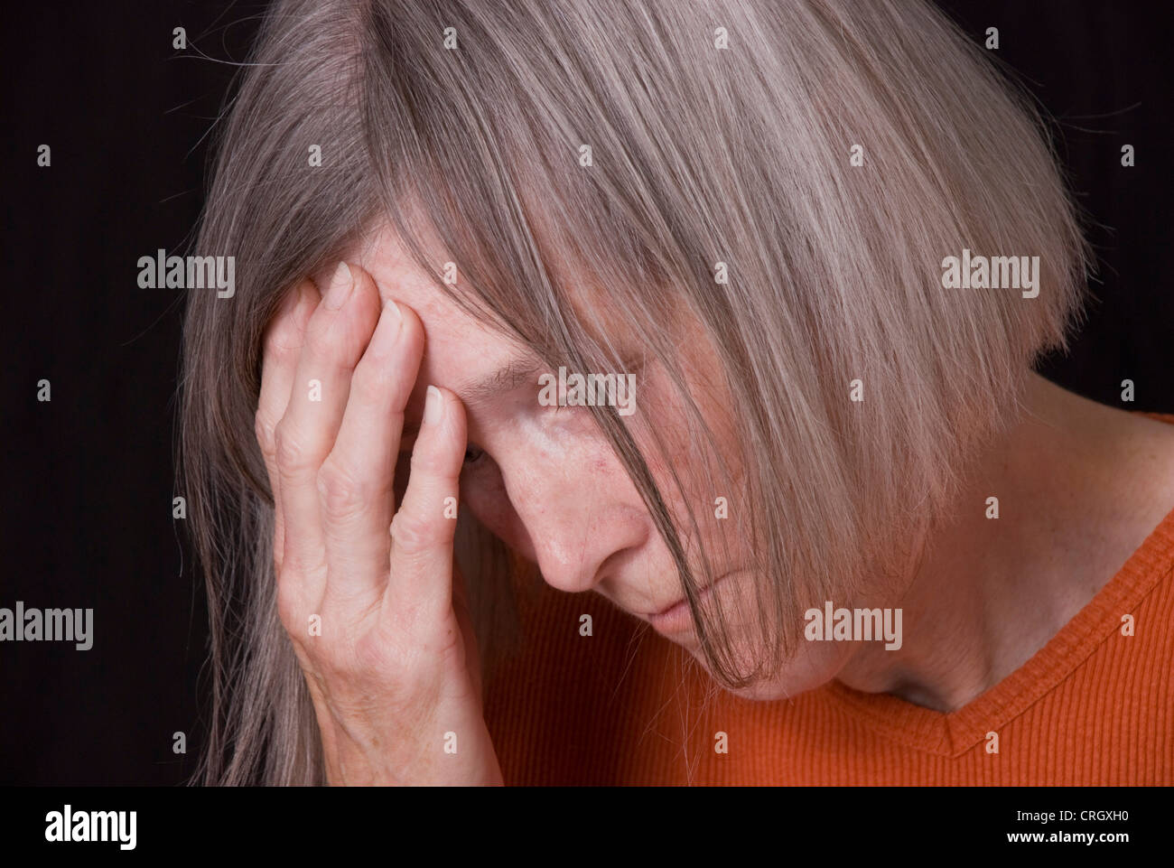 desperate, elderly woman Stock Photo