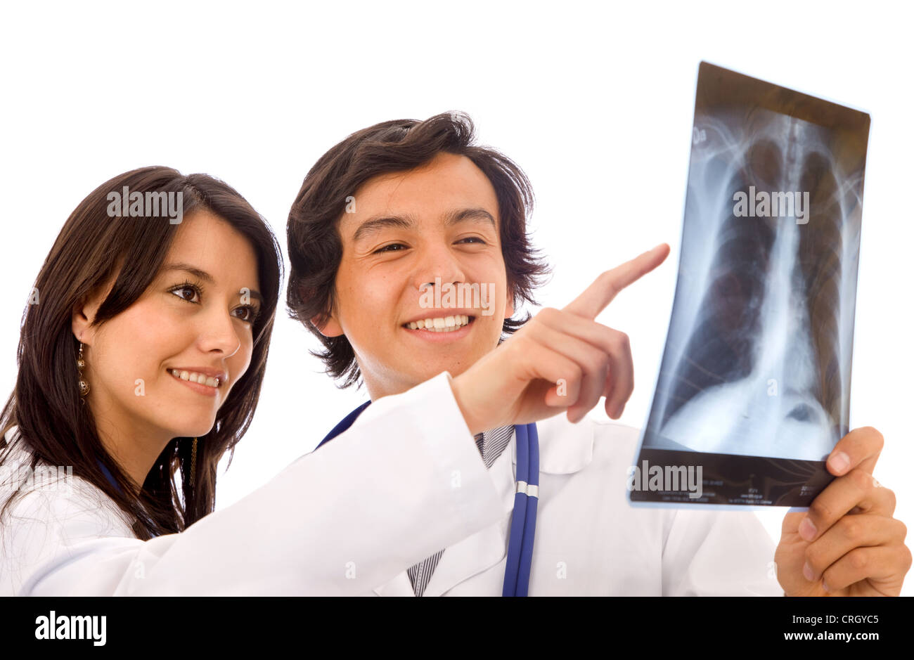 two young doctors looking at an xray, the woman is pointing at the image Stock Photo