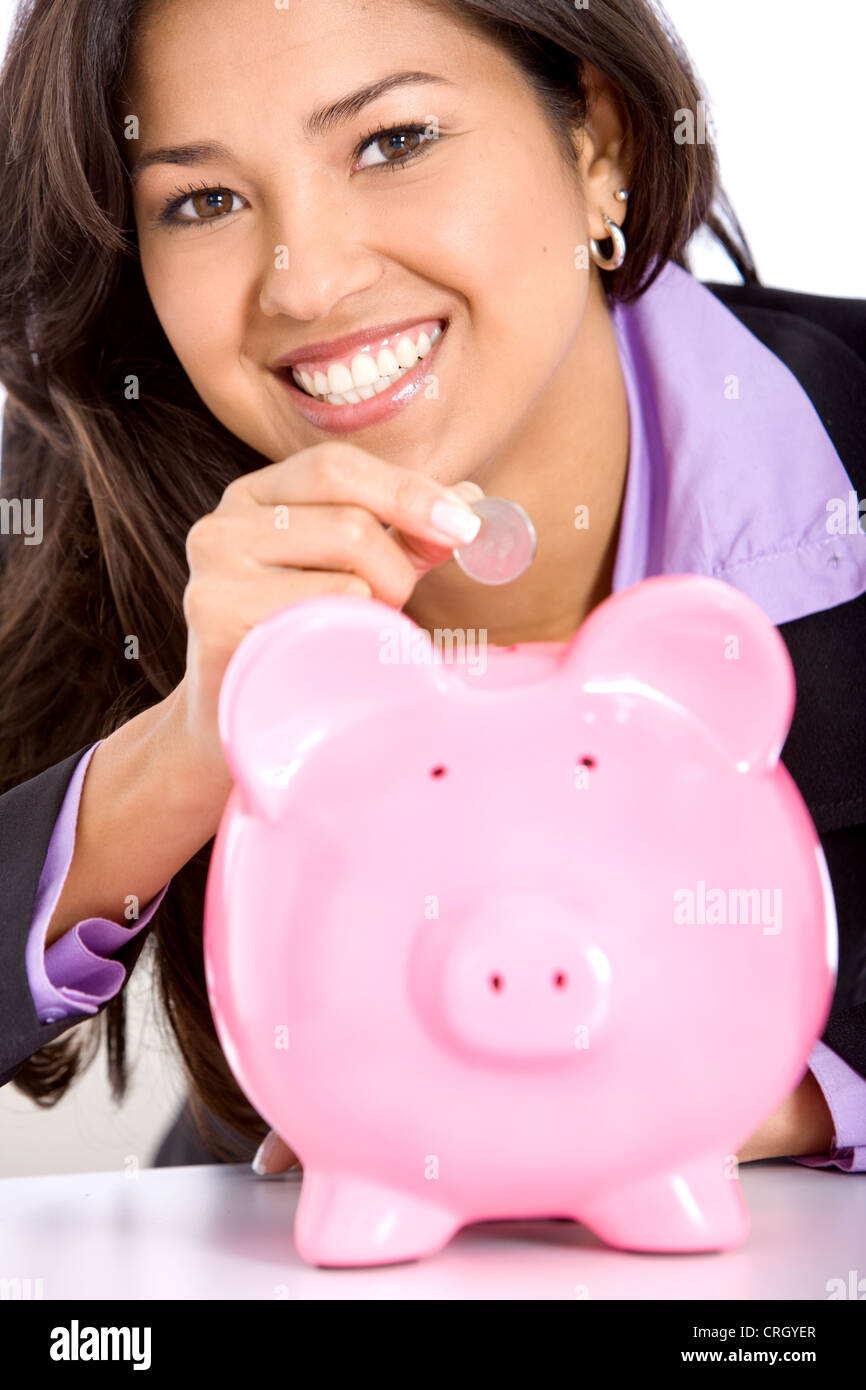 business woman dropping a coin in a piggy bank Stock Photo