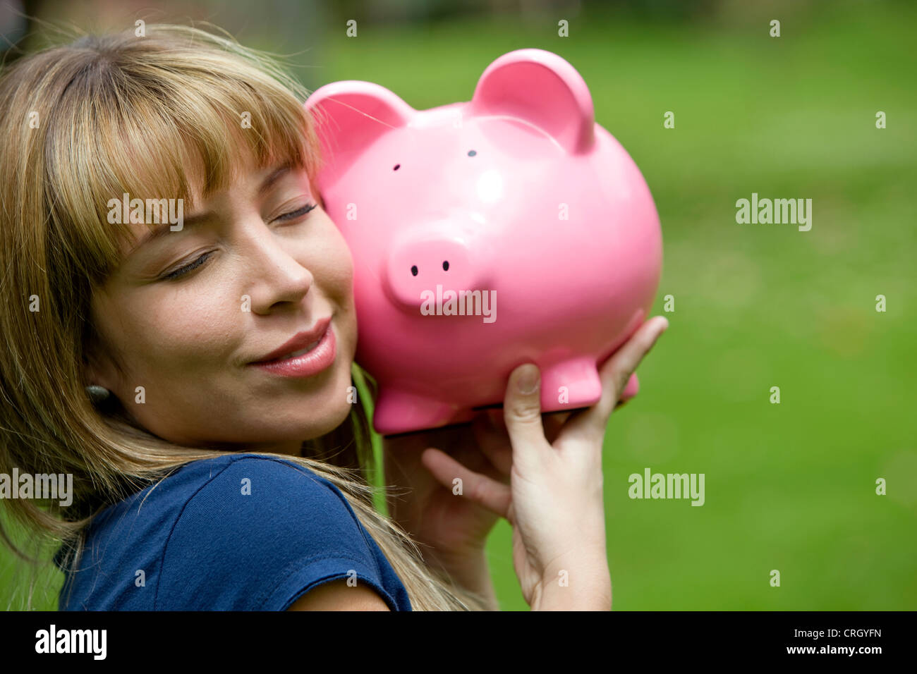 woman holding and hugging a piggy bank Stock Photo - Alamy