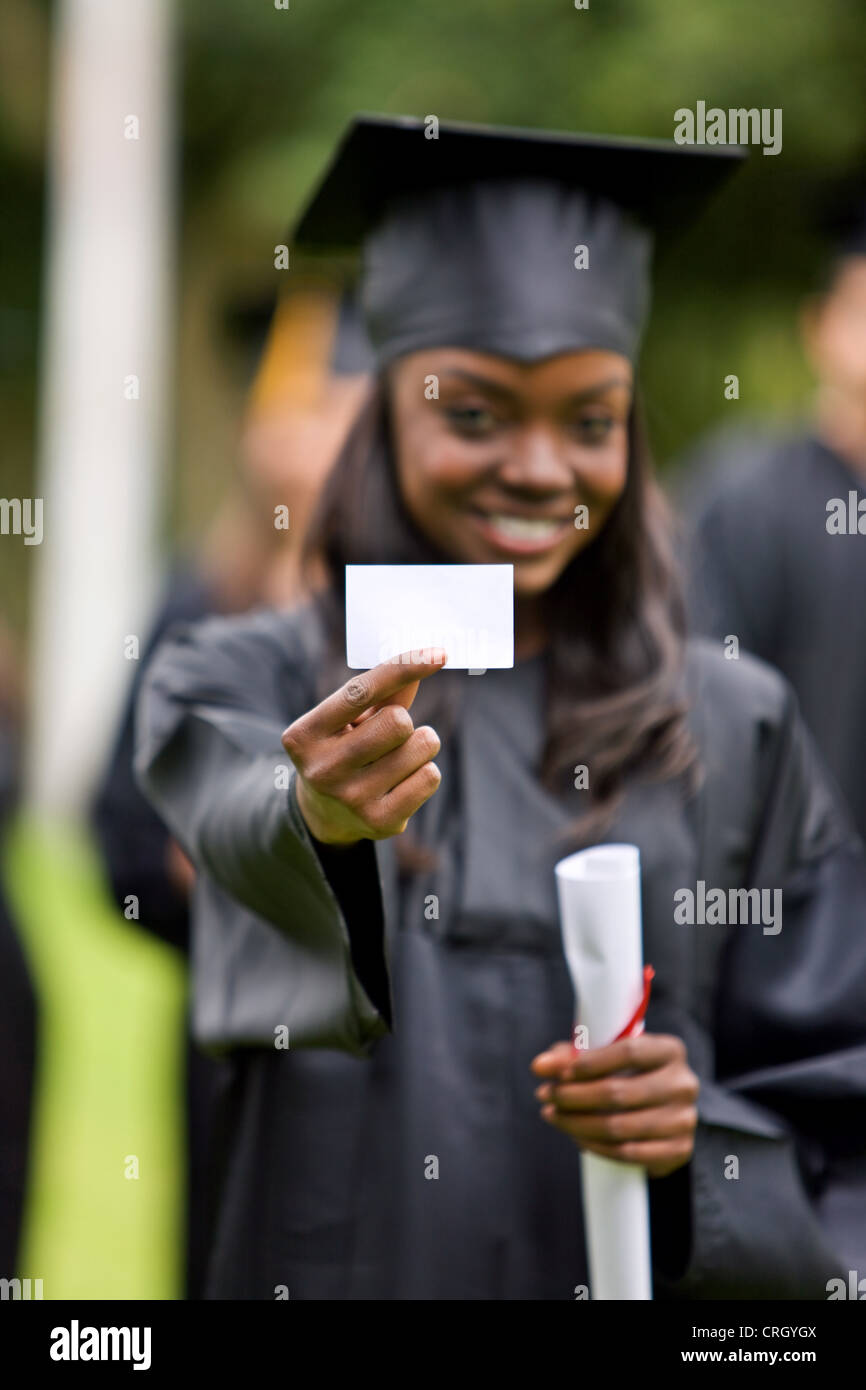 graduate woman displaying a business card Stock Photo