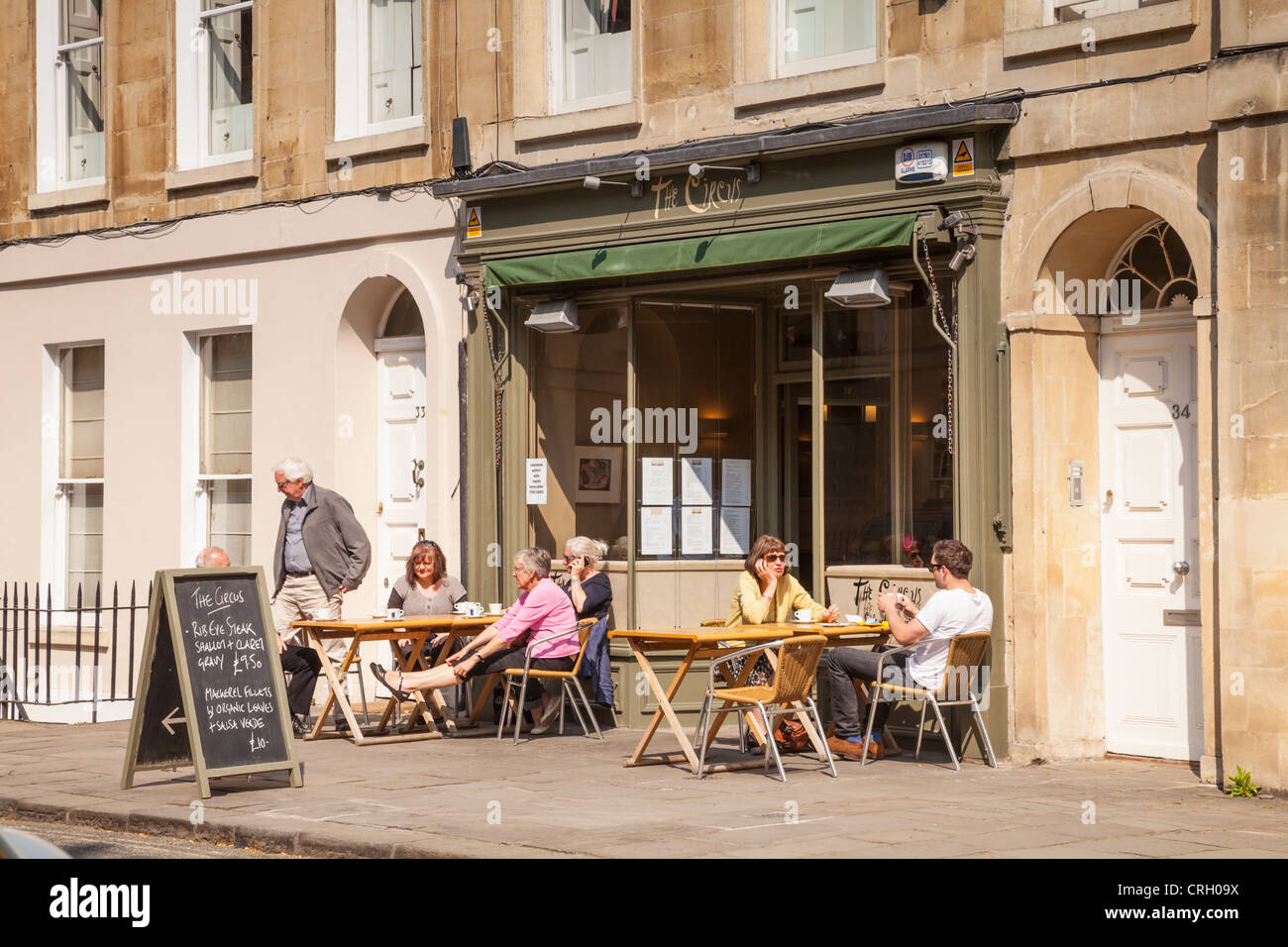 A pavement cafe near the Circus, Bath, with people sitting outdoors on a warm spring day Stock Photo