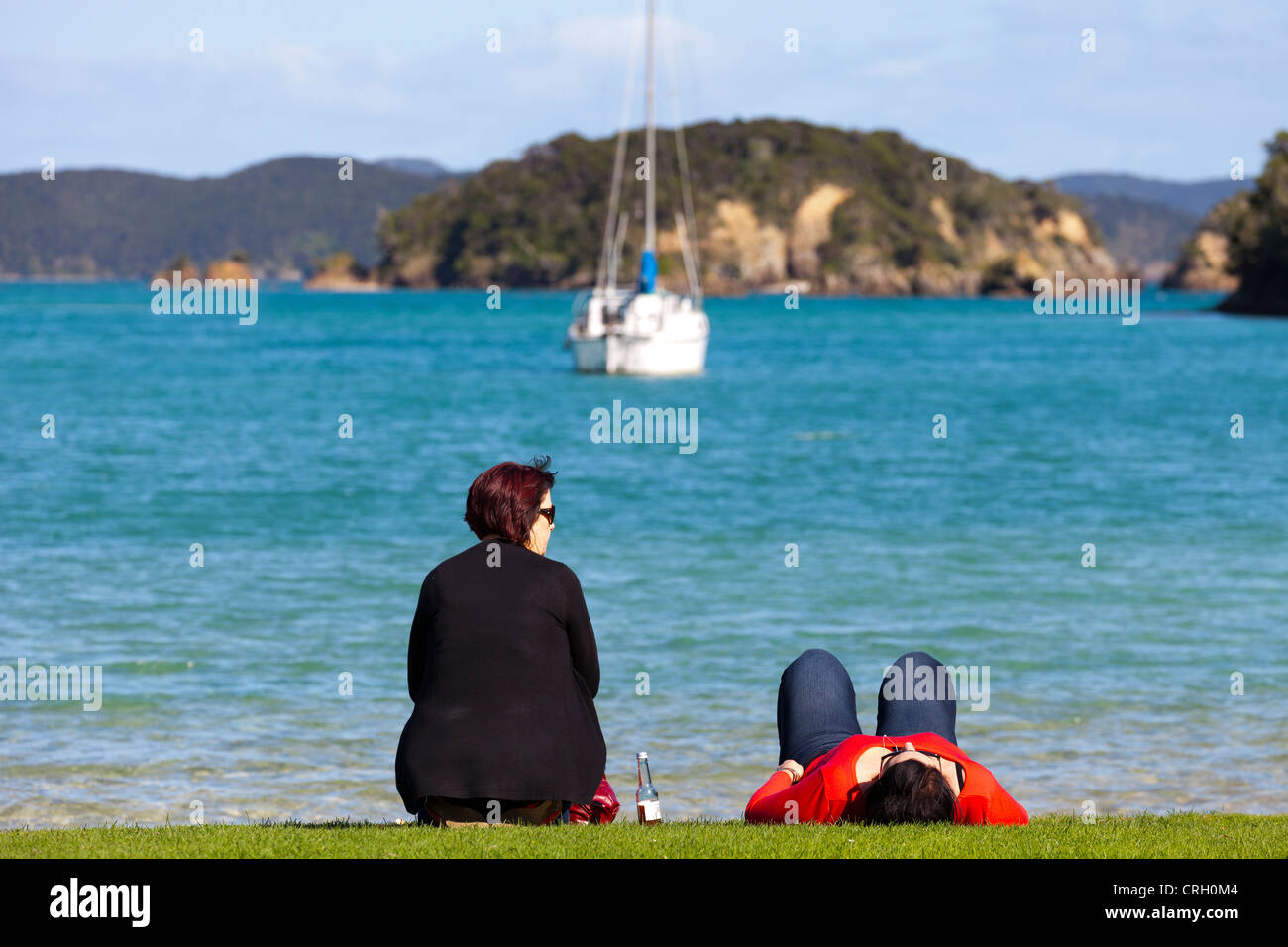 Two ladies on the shore - Bay of Islands, New Zealand 3 Stock Photo