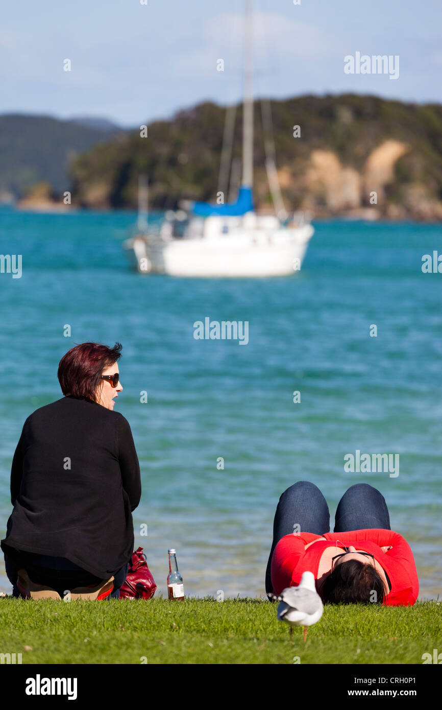 Two ladies on the shore - Bay of Islands, New Zealand 6 Stock Photo