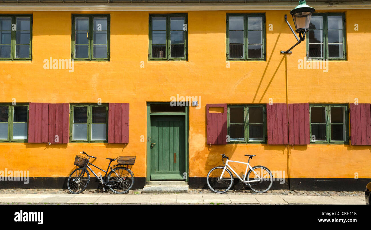 Row of old yellow painted houses at Nyboder, Copenhagen, Denmark Stock Photo