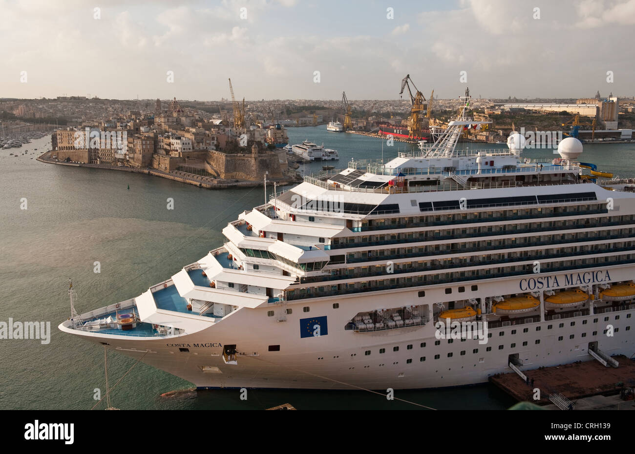 The Costa Magica cruise ship moored in the Grand Harbour of Valletta, Malta, with Fort St Michael in the background Stock Photo