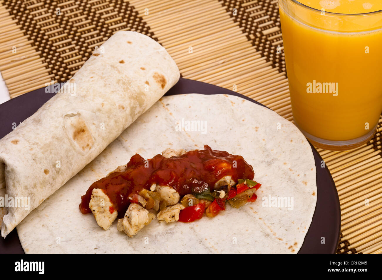 Burritos with chicken pepper onion garlic and sauce Stock Photo Alamy