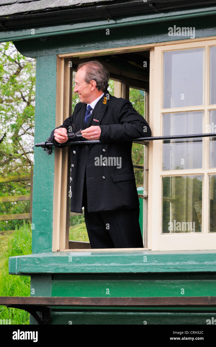 A signalman looking out of a window in his signalbox Stock Photo - Alamy