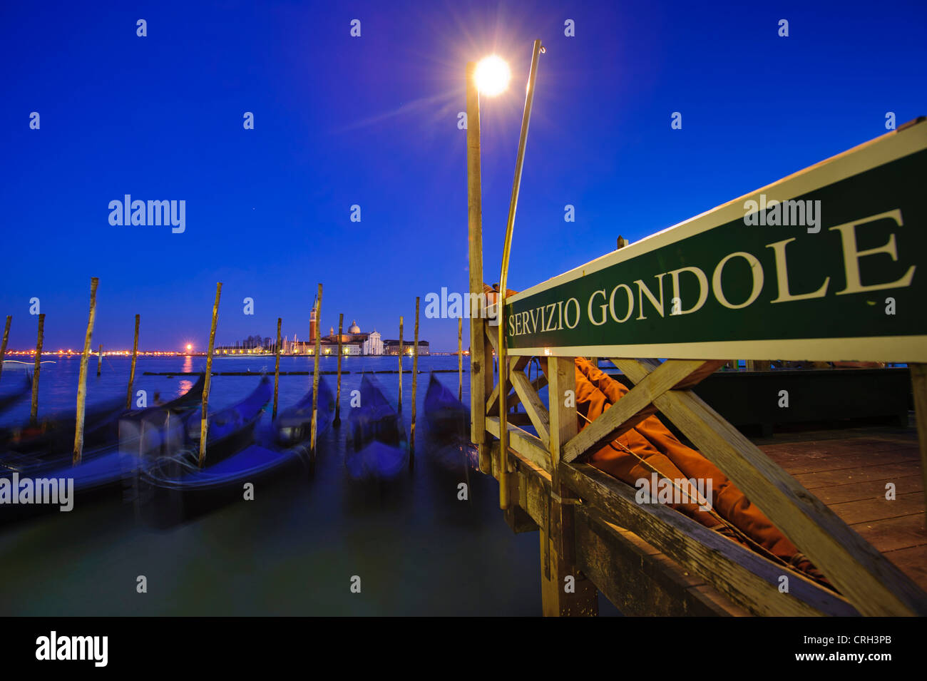 Gondolas moored in front of the Basilica of San Giorgio Maggiore at nightime, Venice, Veneto, Italy Stock Photo