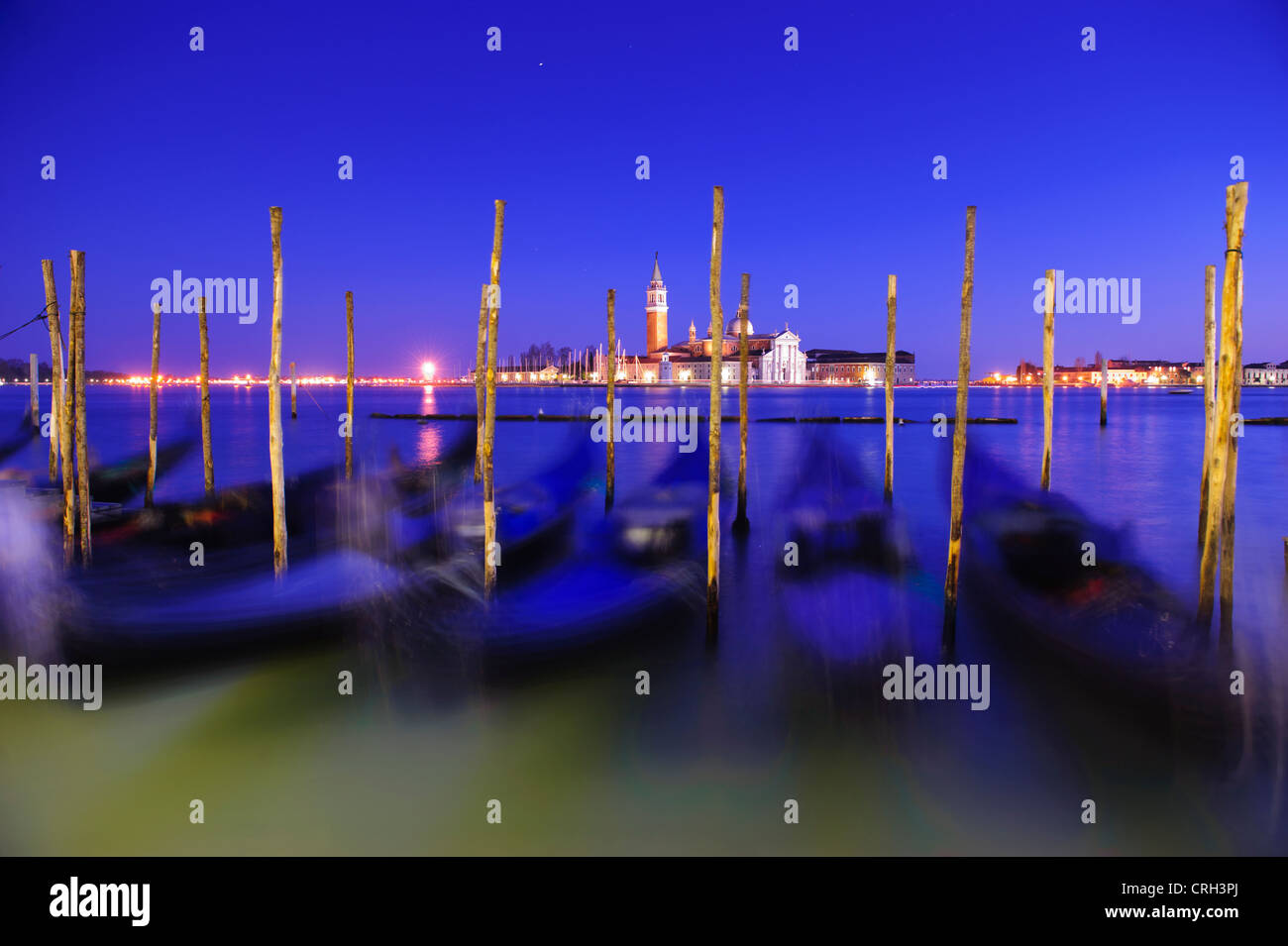 Gondolas moored in front of the Basilica of San Giorgio Maggiore at nightime, Venice, Veneto, Italy Stock Photo
