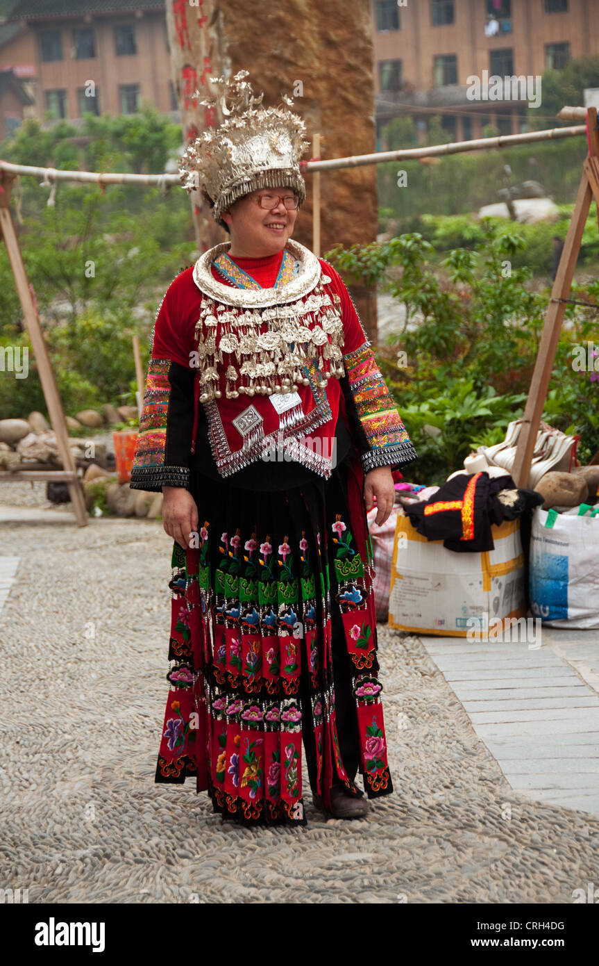 A Chinese tourist wearing traditional Miao clothes and jewels rented,  Xijiang Miao village, China Stock Photo - Alamy