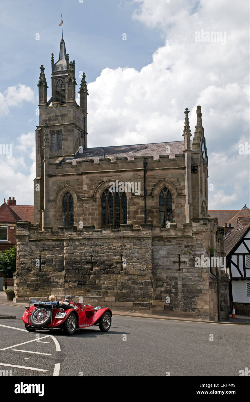 Chapel of St Peter on top of ancient medieval city wall at East Gate Warwick England with red MG 1930s sports car Stock Photo