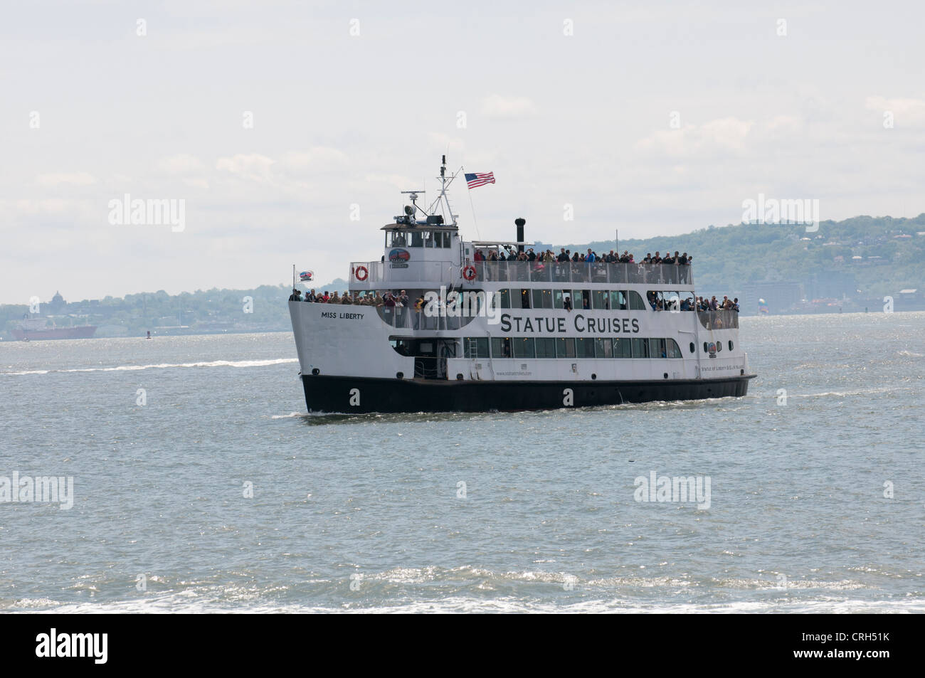 Tour boat crossing New York Harbor Miss Liberty of Statue Cruises Stock