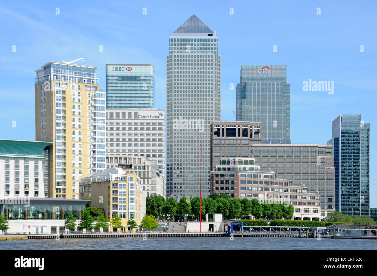 View across River Thames at high tide towards London Docklands Canary Wharf skyline Stock Photo