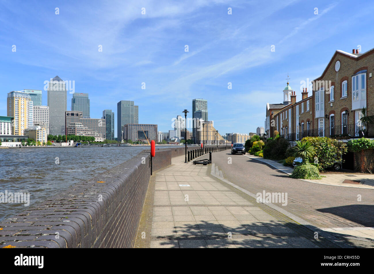 Modern gated housing development beside River Thames opposite the Canary Wharf docklands complex Stock Photo