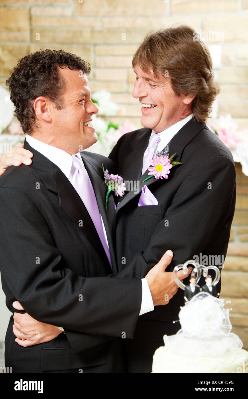 Gay male couple embracing on their wedding day.  Stock Photo