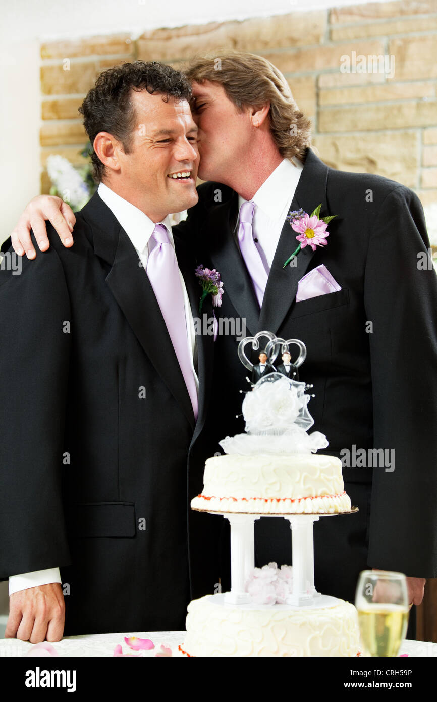 One groom at a gay marriage kissing his husband lovingly on the cheek.  Stock Photo