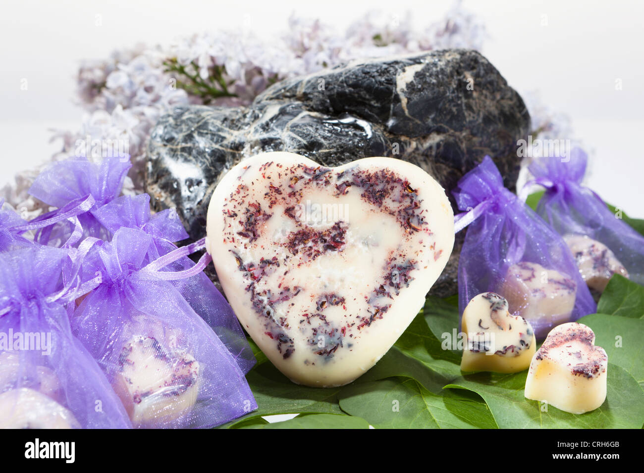 Body butter hearts with or without chiffon sachets in front of a stone Stock Photo