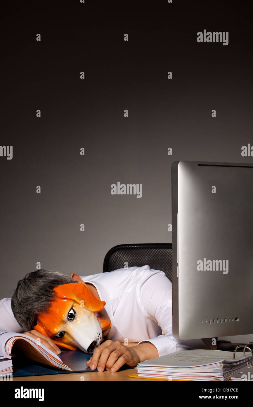Business Executive In Dog Mask Laying On Work Desk With Files And