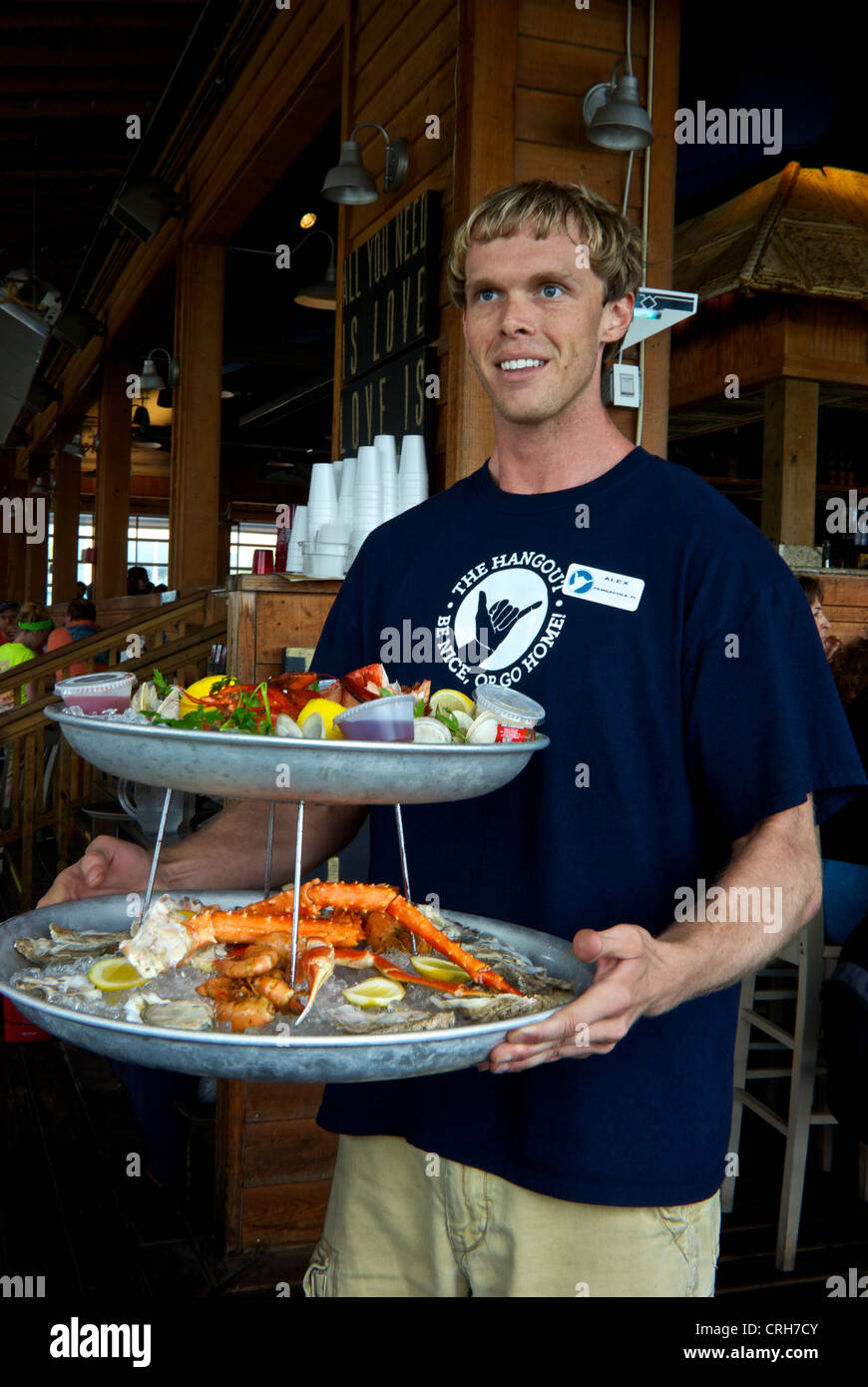 The Hangout Restaurant waiter two tier serving tray assorted cooked raw shellfish appetizers on ice Stock Photo
