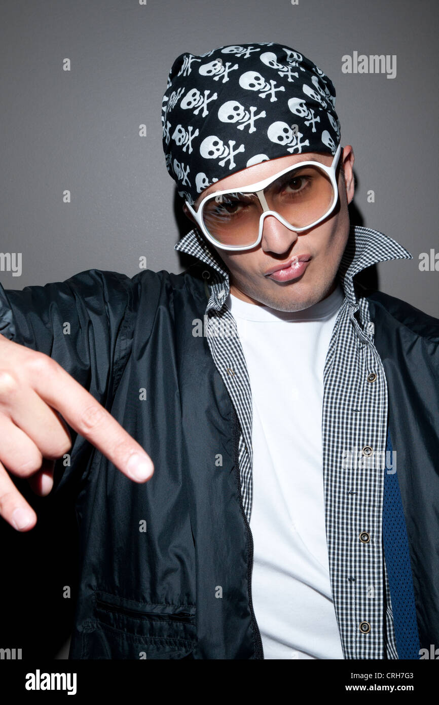 Portrait of a stylish young man giving rock hand gesture Stock Photo ...