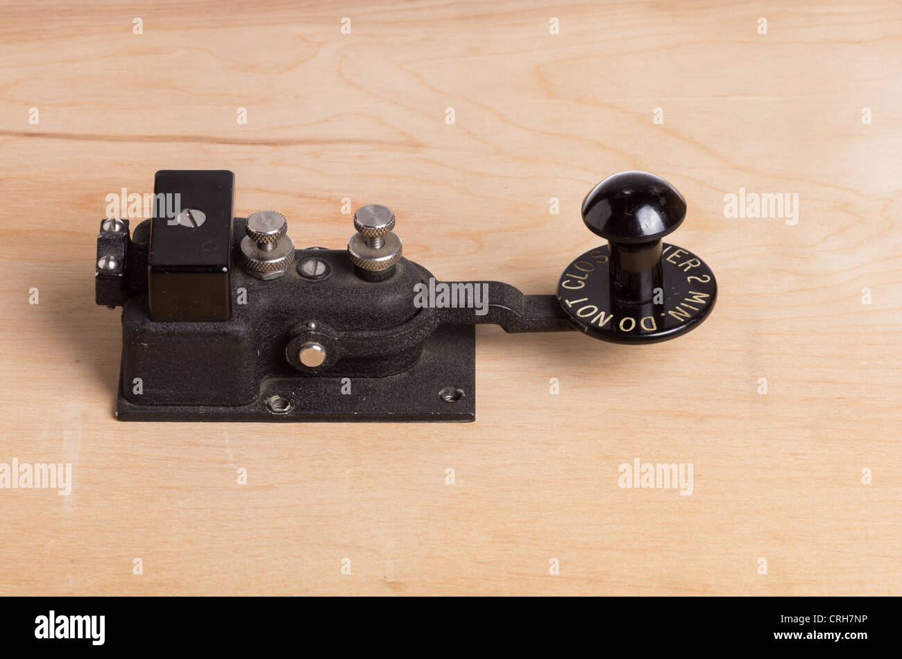 A vintage telegraph key sitting on a desk Stock Photo