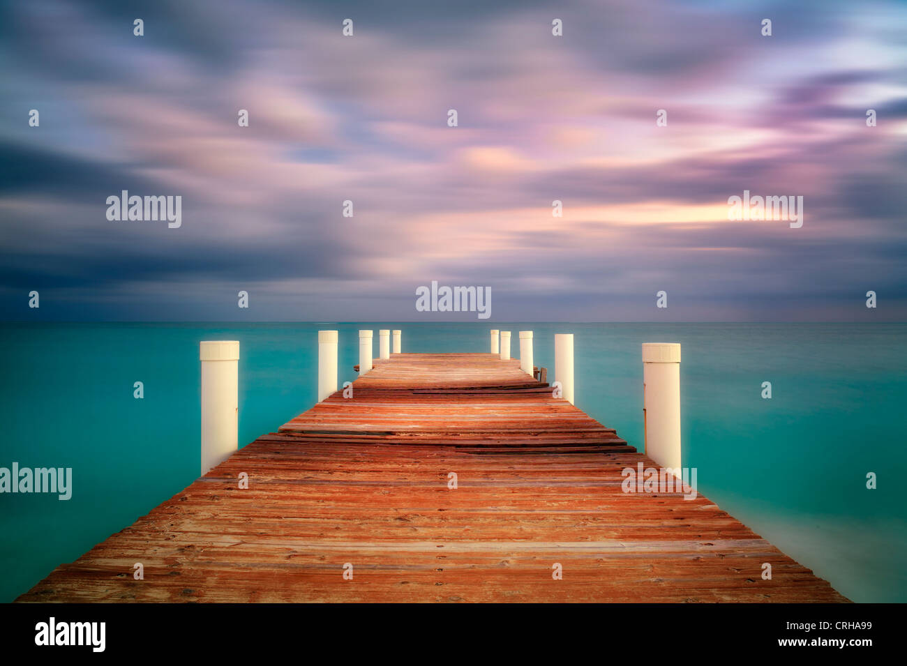 Pier at sunrise in Grace Bay. Providenciales. Turks and Caicos. Stock Photo