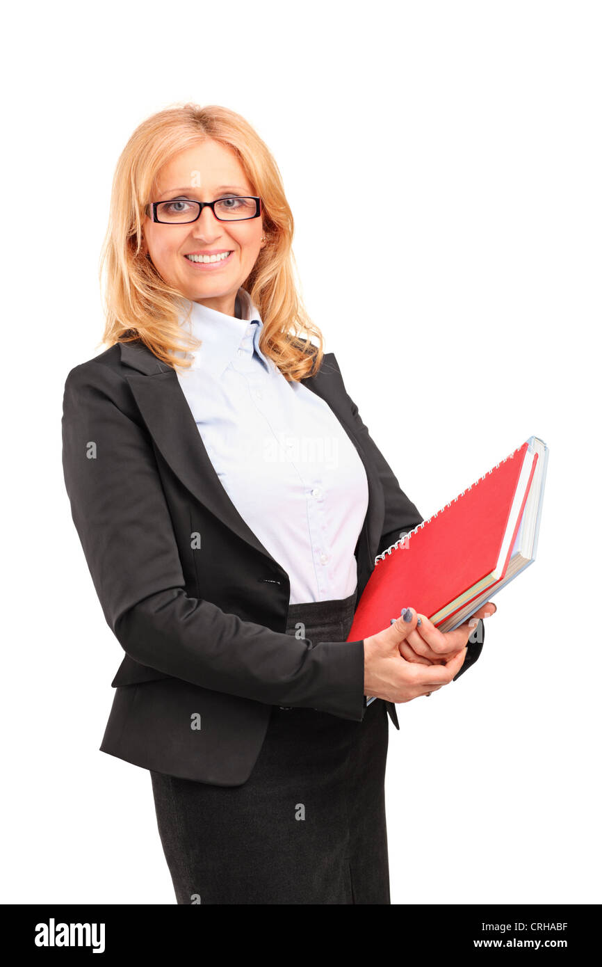 A smiling female teacher holding a notebook isolated on white background Stock Photo