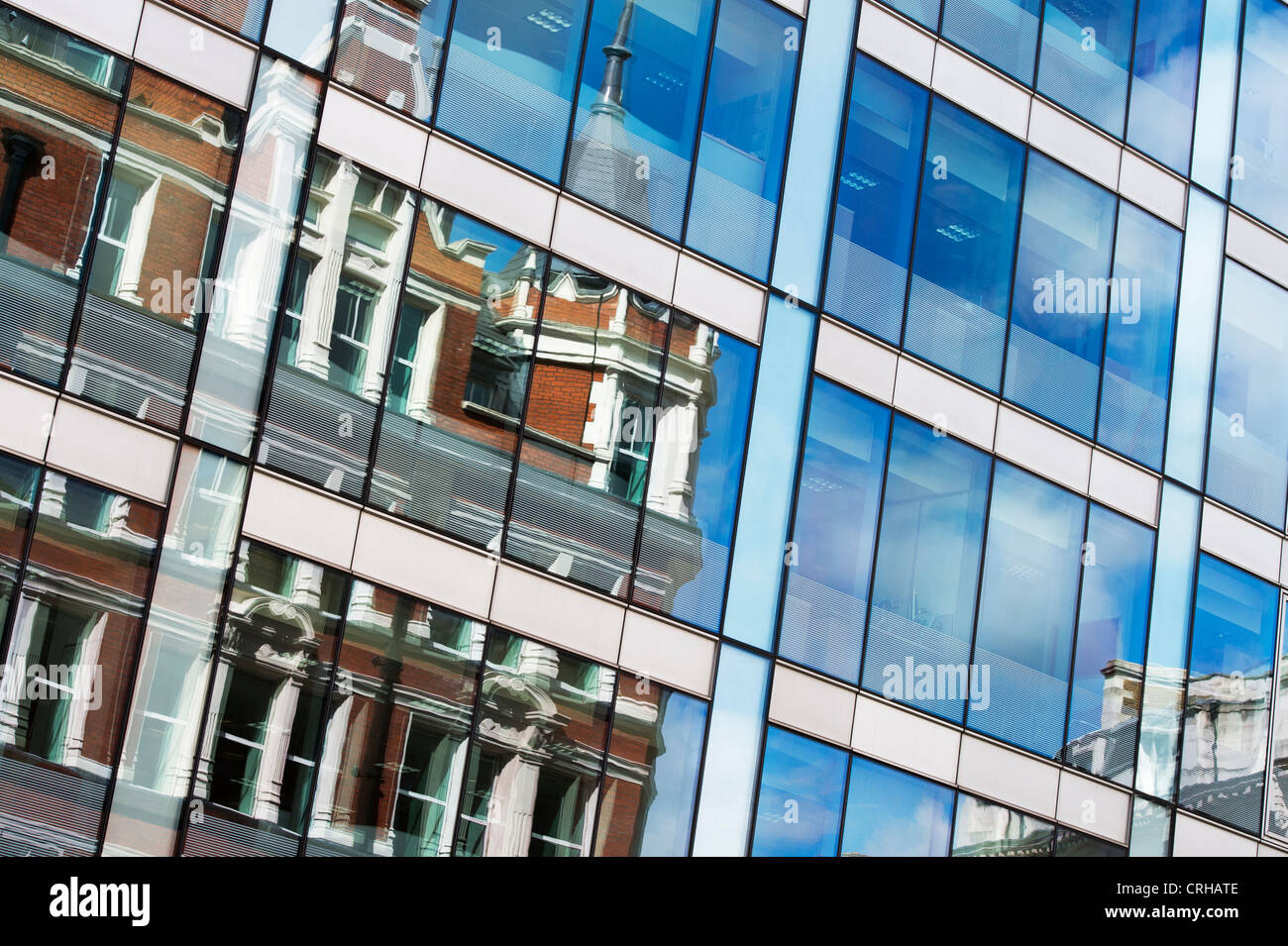 Buildings reflecting in office block glass windows in High Holburn road. London Stock Photo