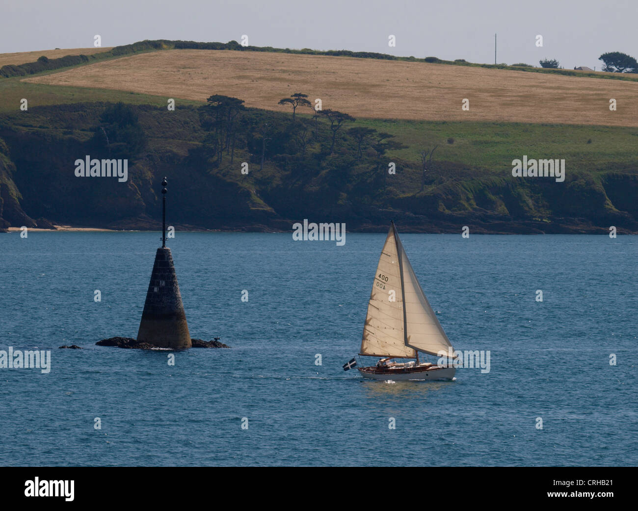 Yacht sailing past Black rock, Carrick Roads, falmouth bay, Cornwall, UK Stock Photo