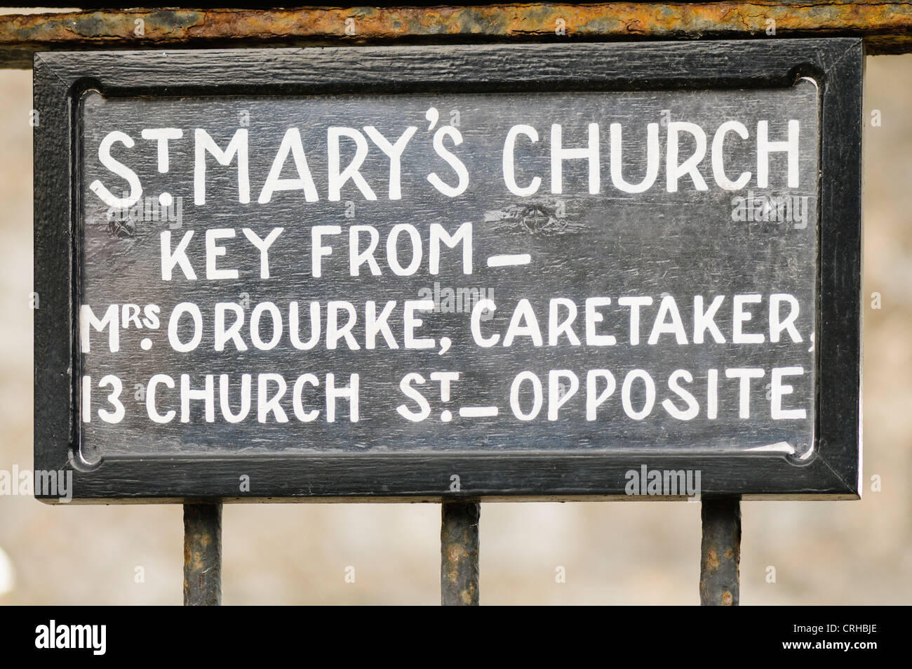 Sign indicating that key for a church can be obtained from a keyholder Stock Photo