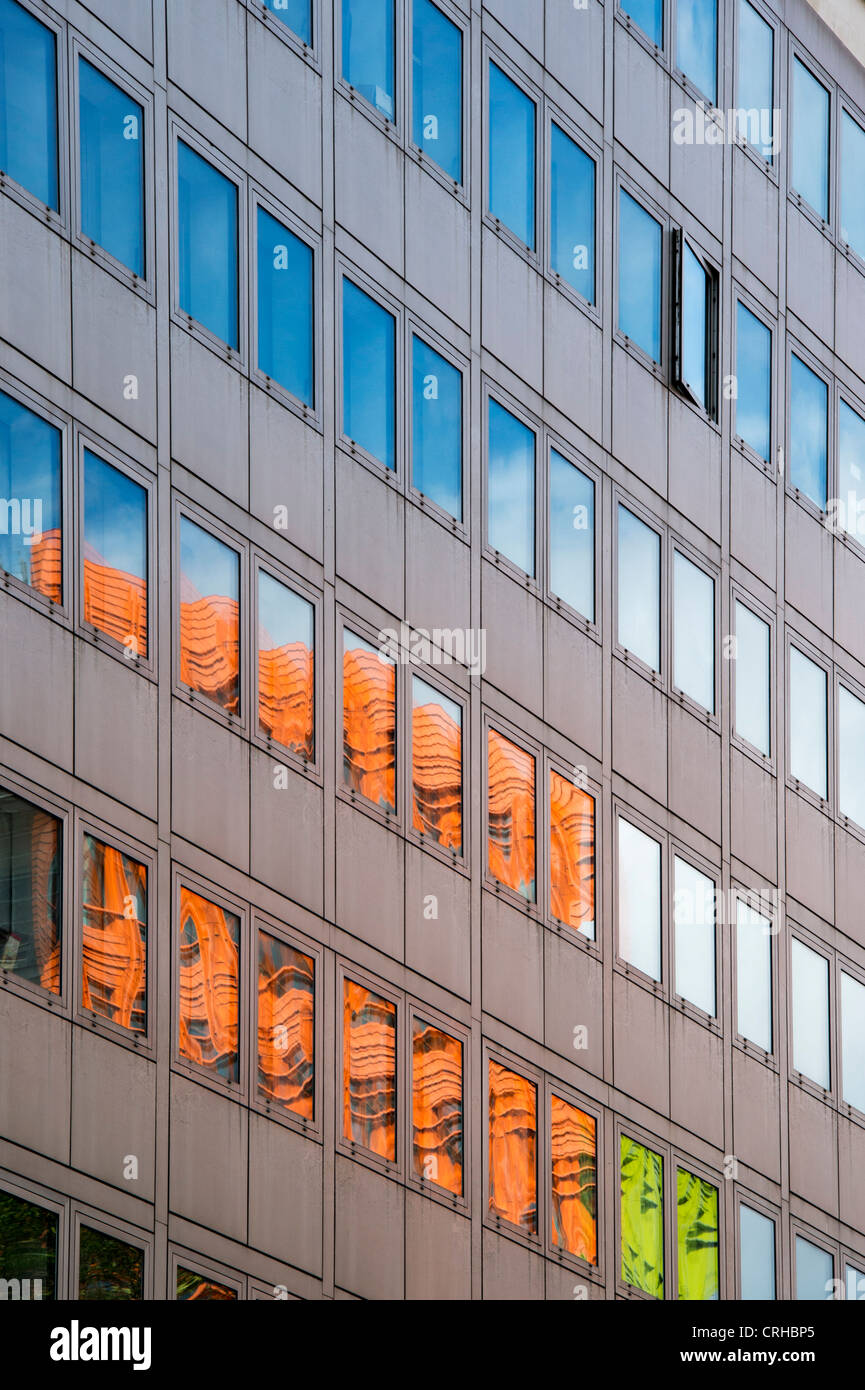 Central St Giles buildings reflecting in office block glass windows in High Holburn road. London Stock Photo