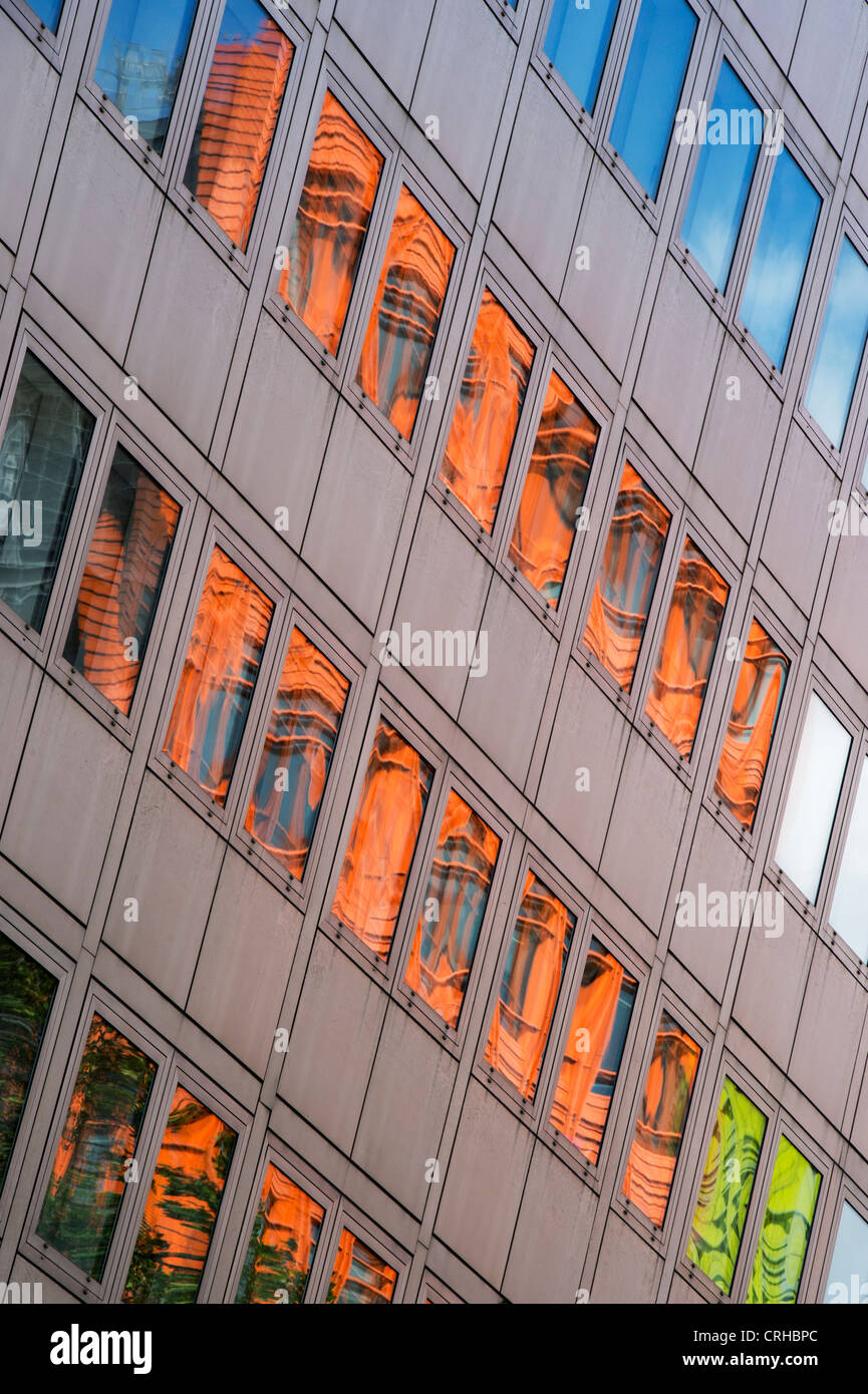 Central St Giles buildings reflecting in office block glass windows in High Holburn road. London Stock Photo