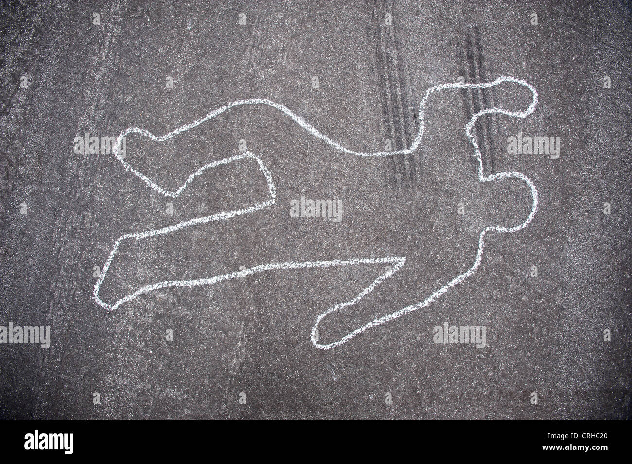 Crime scene chalk line of an auto accident with tire skid marks leading over the body. Stock Photo