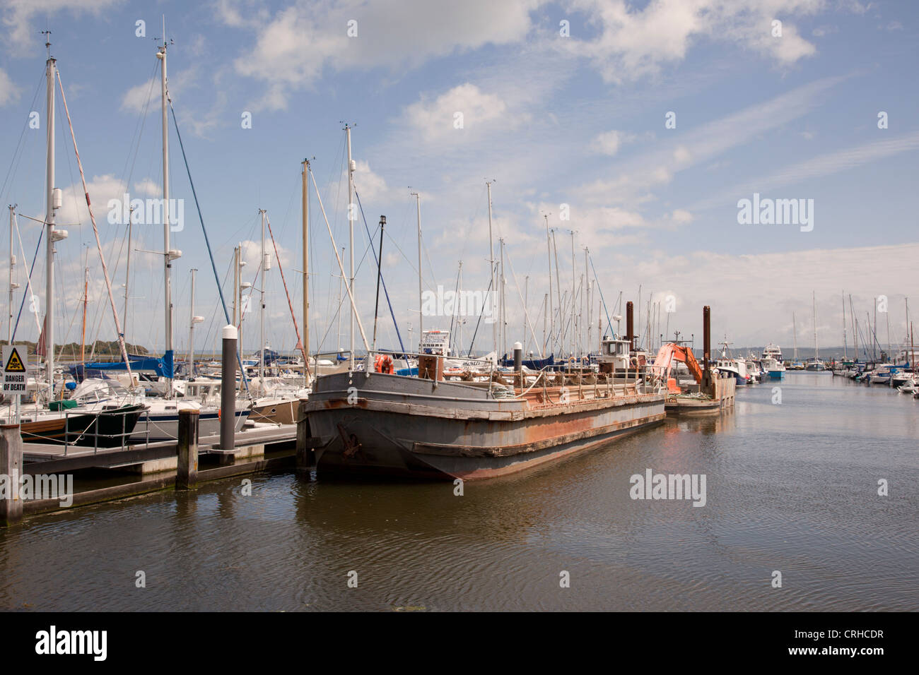 Dredger moored in Lymington marina, Hampshire, England, UK Stock Photo