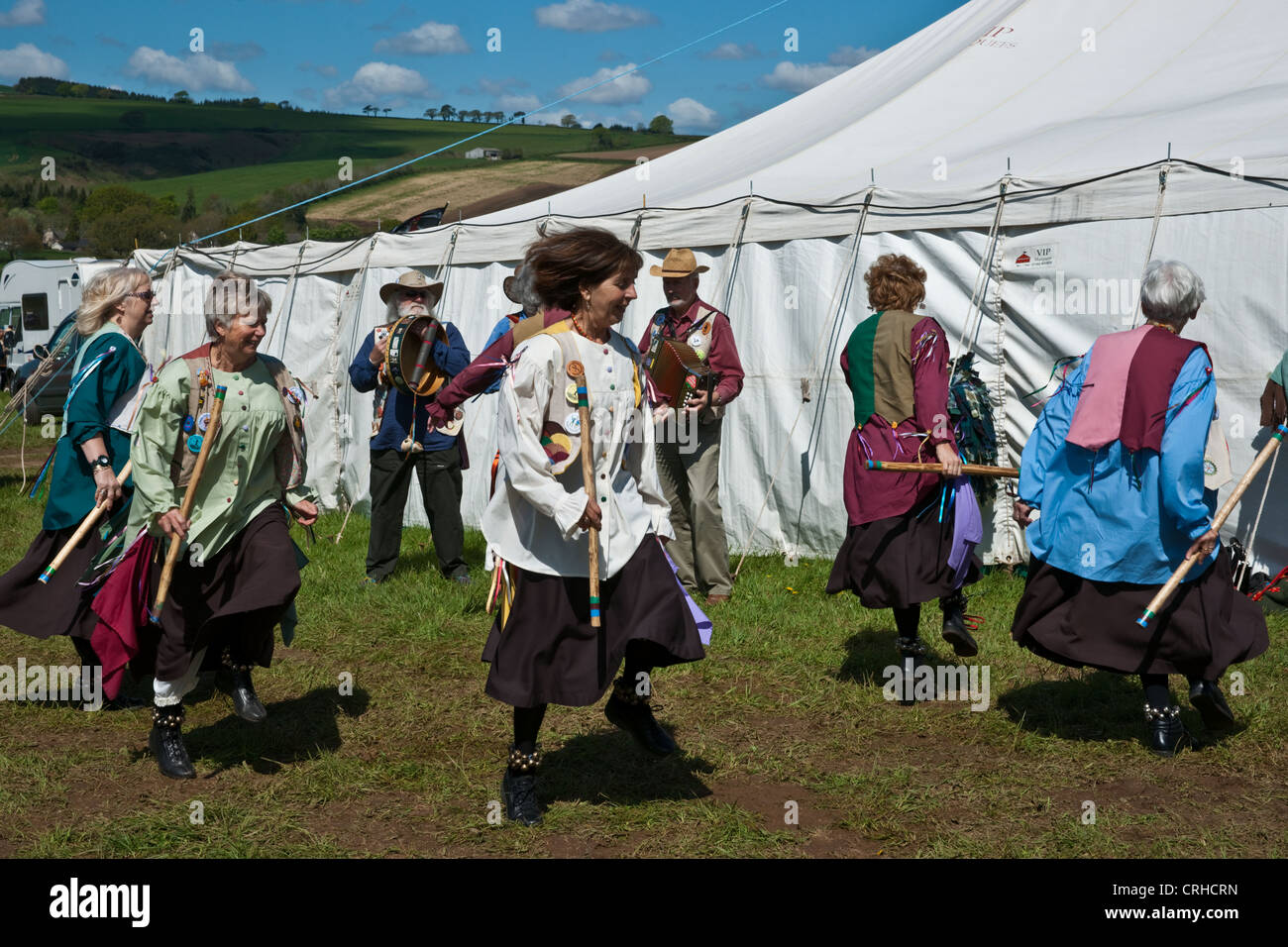 Morris dancers at a country fayre ground dancing in a ring and in lines Stock Photo