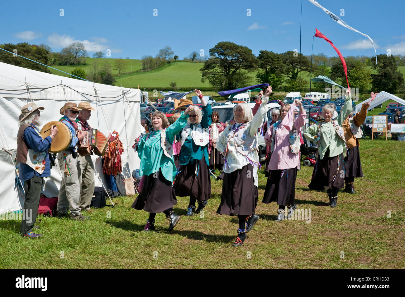 Morris dancers at a country fayre ground dancing in a ring and in lines Stock Photo