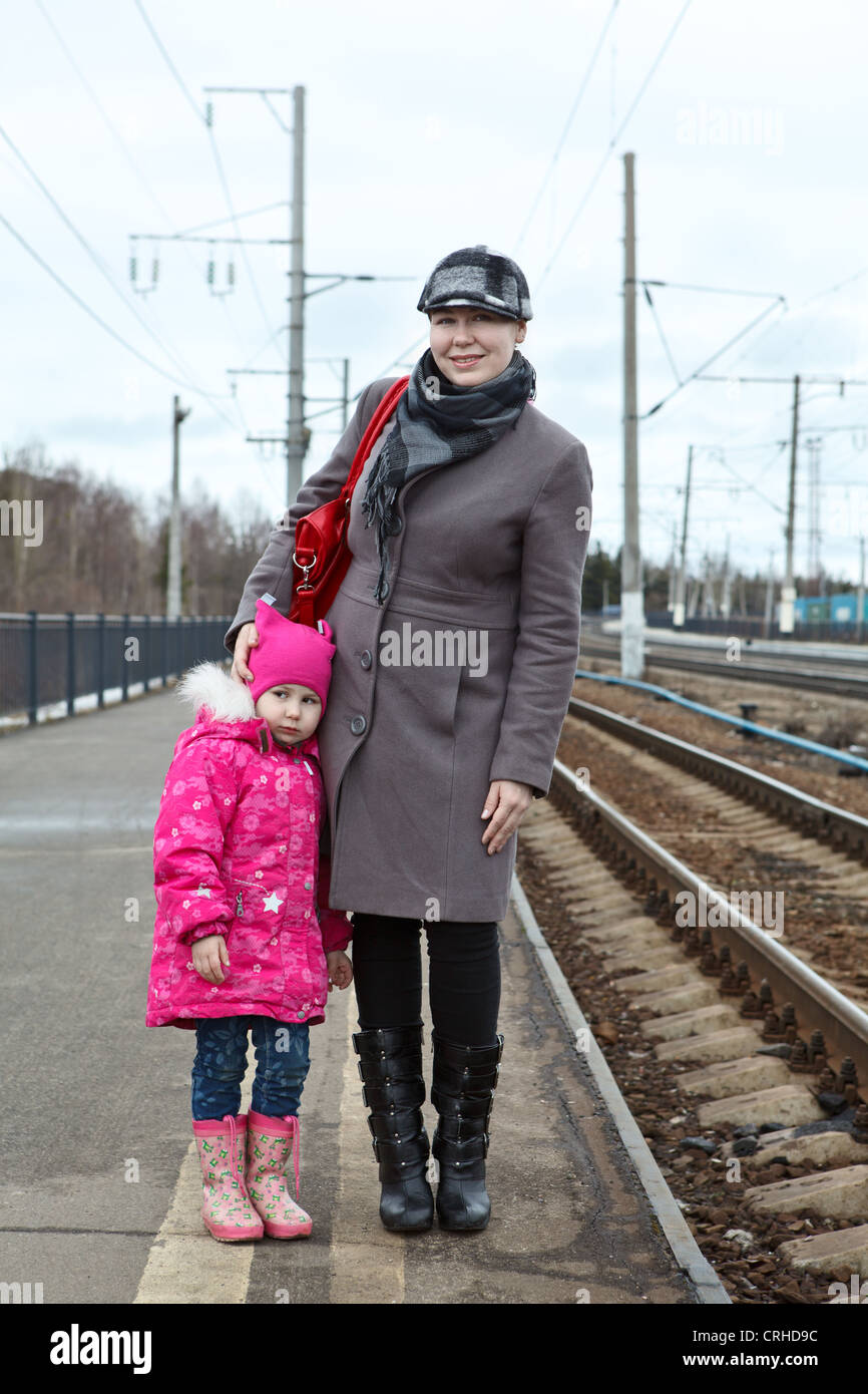 Mother and small daughter standing on railway station platform. Caucasian Russian people, Russia Stock Photo