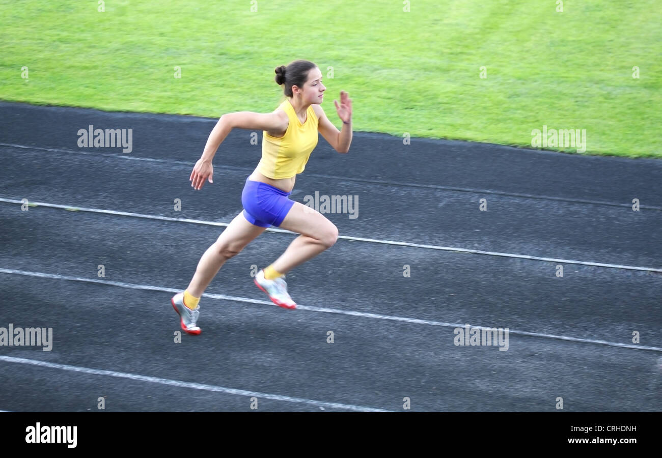 Girl running on the track Stock Photo