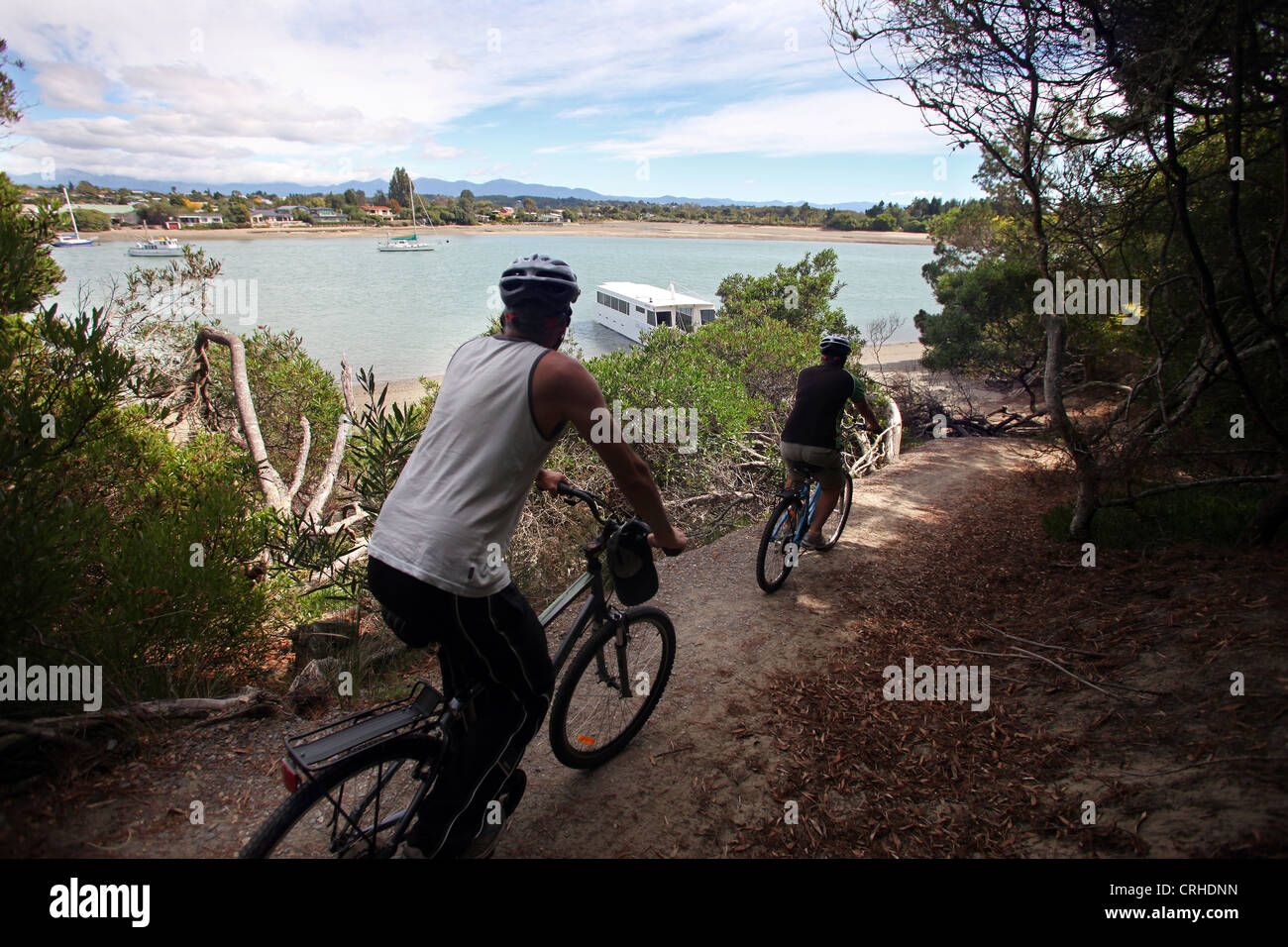 2 cyclists ride to the Flat Bottomed Fairy, the ferry that crosses from