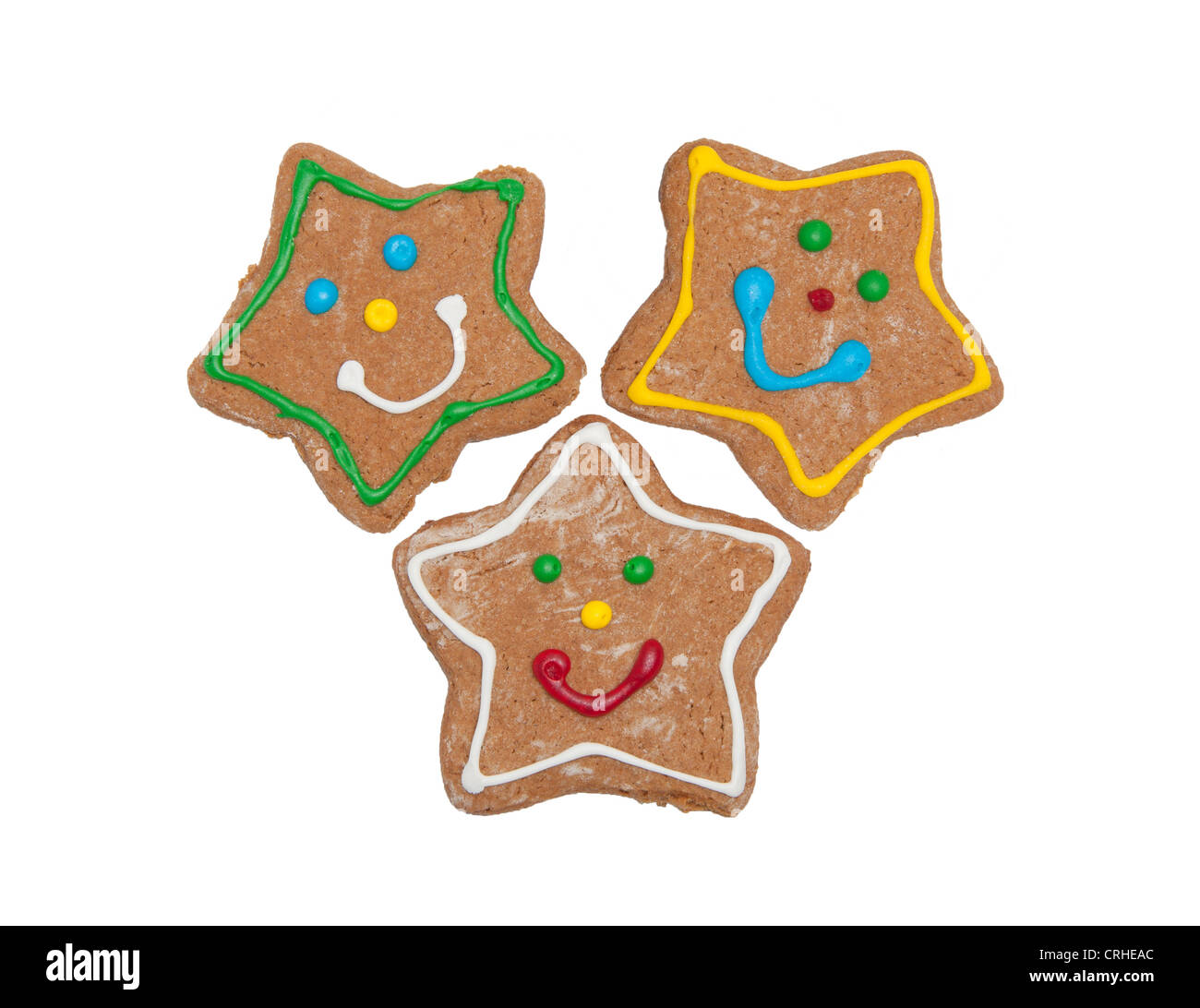 Thee Christmas gingerbread star cookies with colorful, happy icing, on white Stock Photo