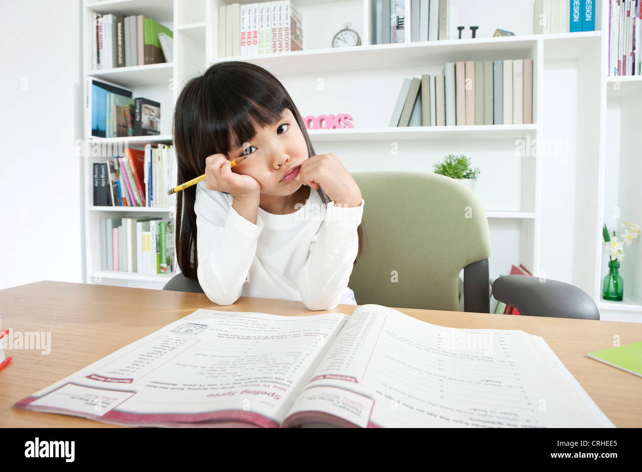 Little girl studying at desk Stock Photo - Alamy