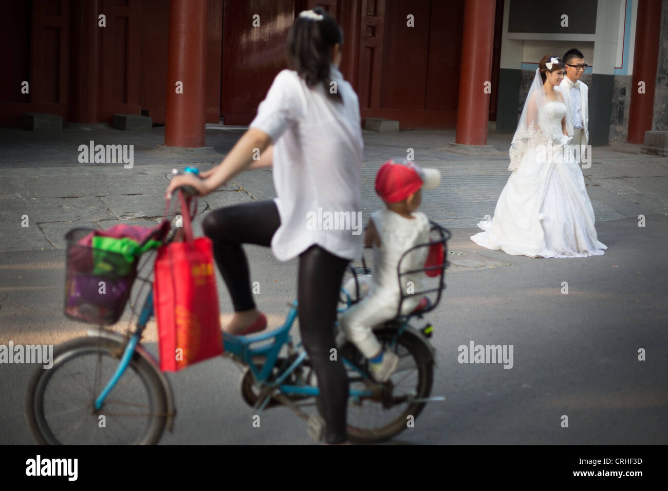 A couple pose for wedding photos in Guozijian Jie, near the Confucius Temple, in Beijing, China. Stock Photo